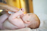 ein Baby spielt mit einen WaterWipes Feuchttuch
