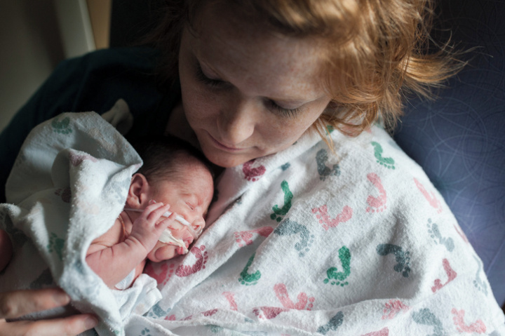 a mother holding her premature baby