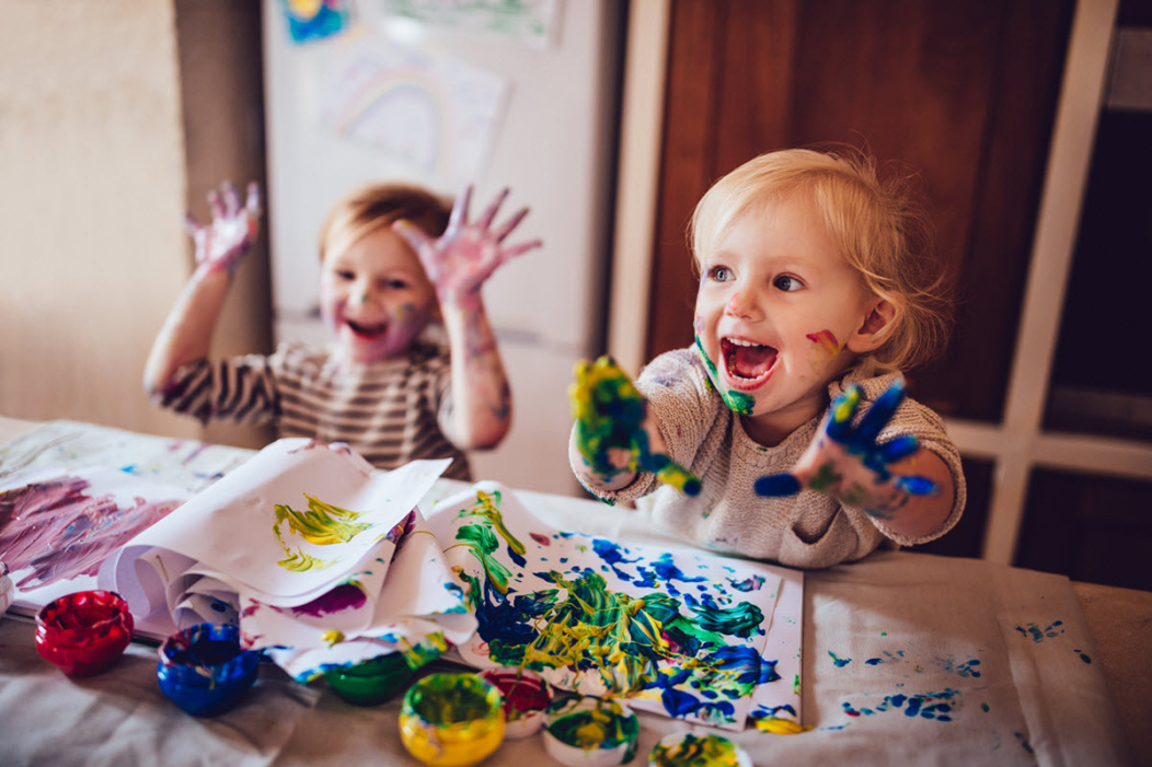 2 toddlers playing with paints