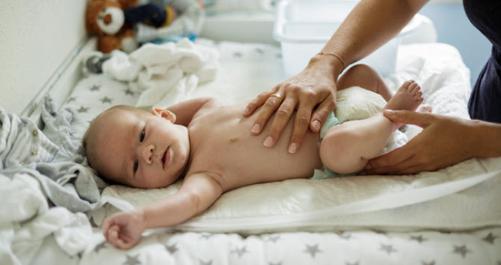 Mother changing a baby's nappy.