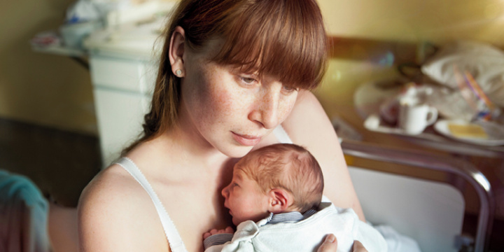 A mother holding her newborn baby