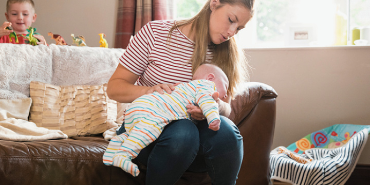 A mother burping her baby