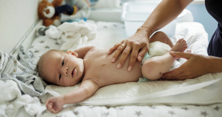 newborn sleeping in baby car seat next to baby changing bag