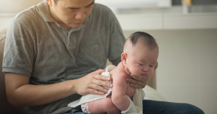 newborn baby lying of sleeping fathers chest