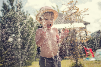 a toddler playing with water