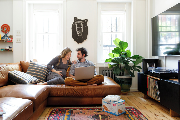 A mother and father putting together a baby registry list.