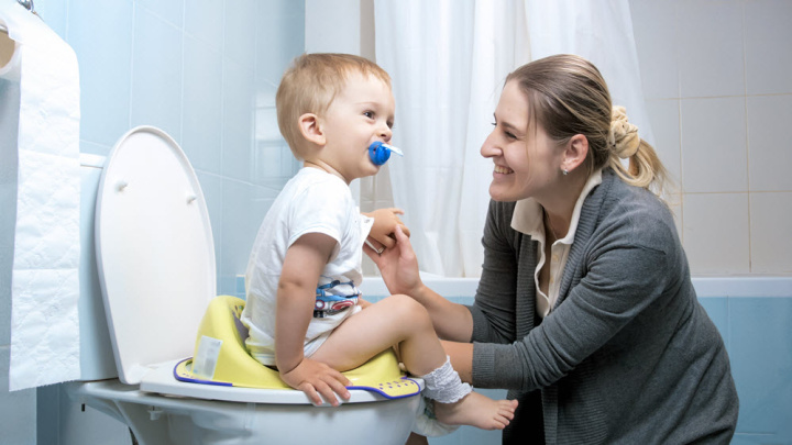 mother and a toddler toilet training