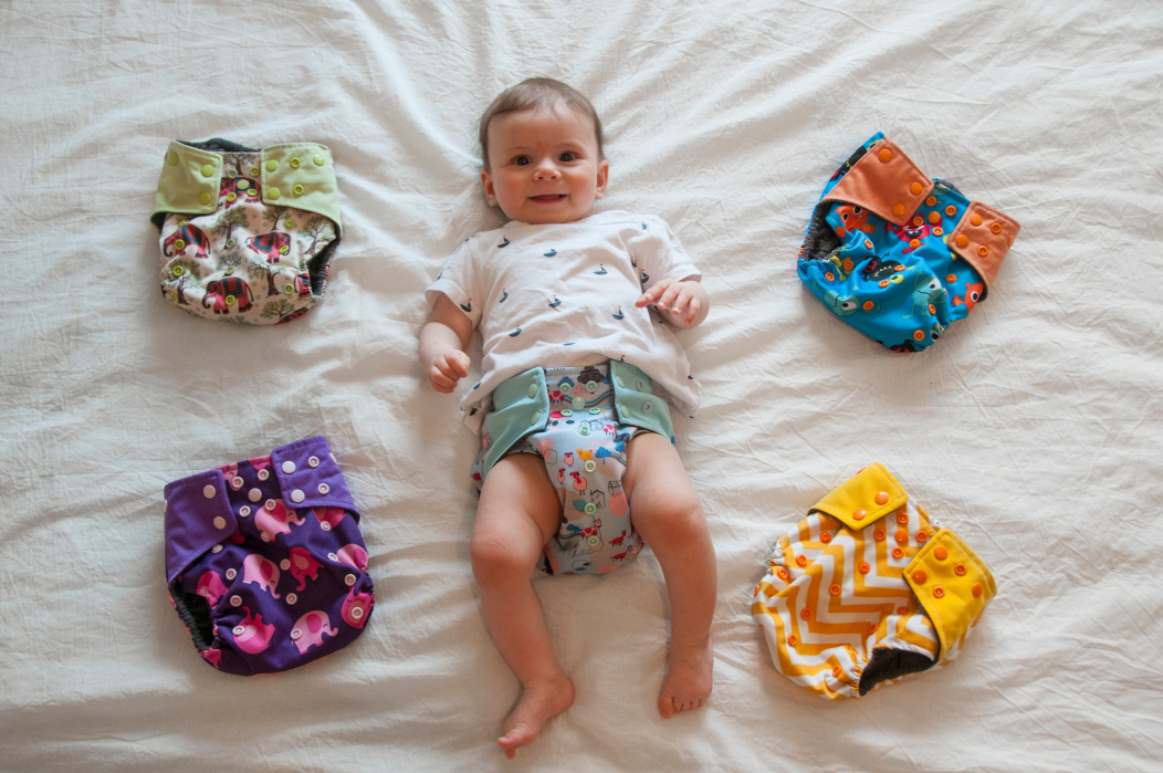 A baby with different types of nappies.