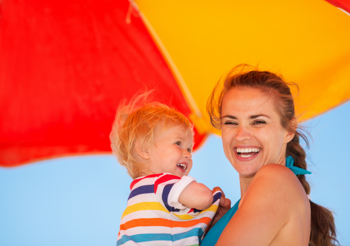 mum and a baby boy smiling in the sun