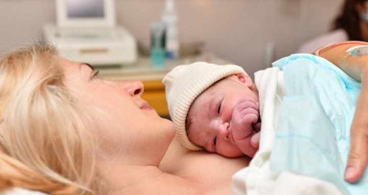 Newborn lying on mothers stomach