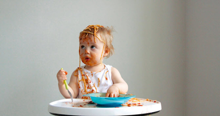 Un bambino che gioca con il cibo