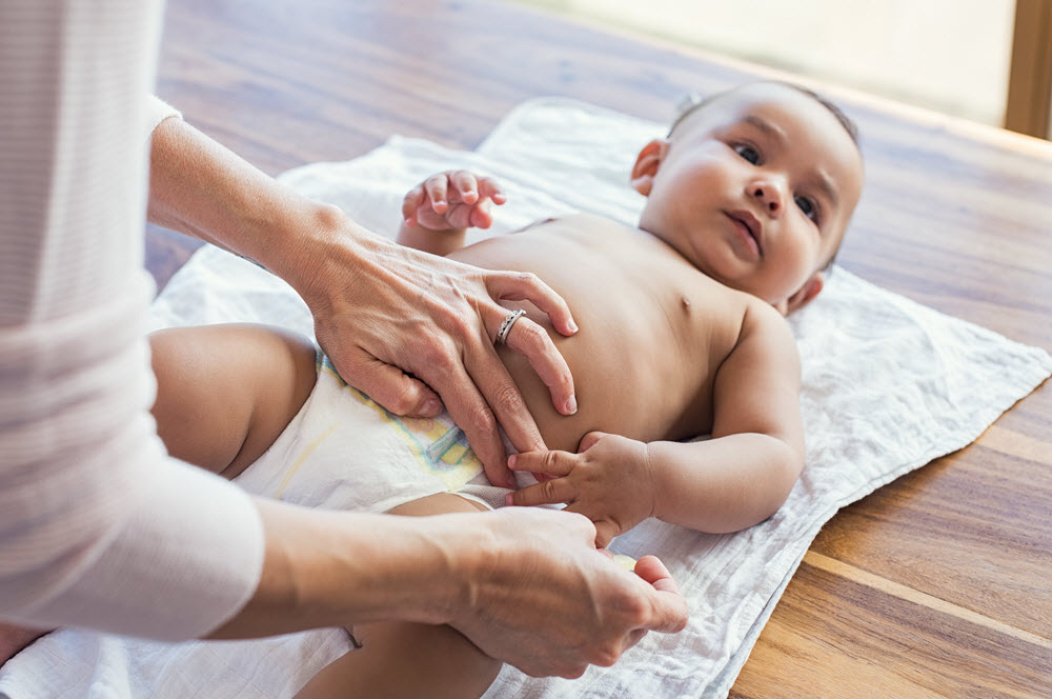 Mother changing baby's diaper