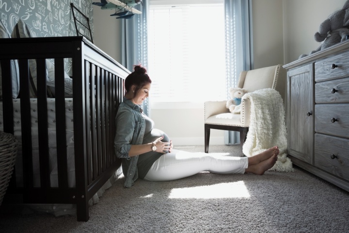 a pregnant mother holding her baby bump