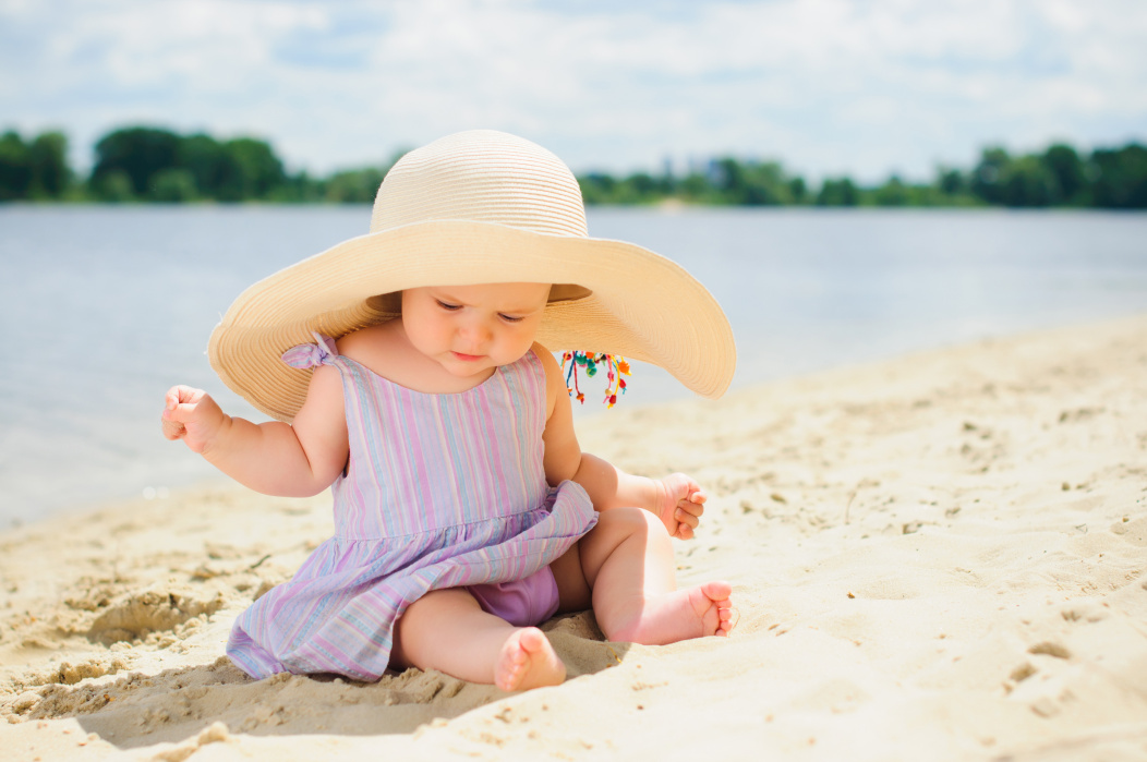 baby girl playing on sand