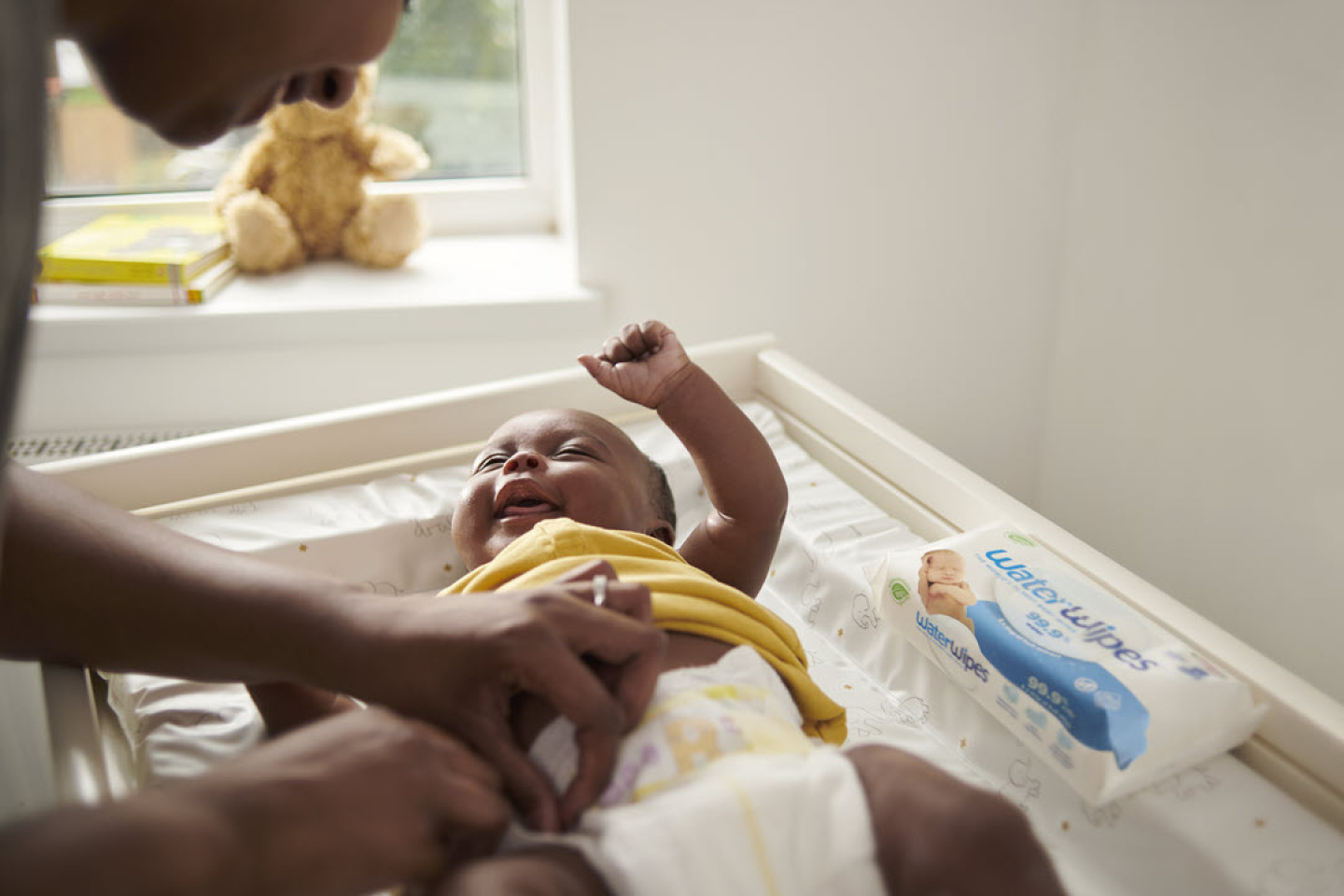  A parent changing its baby's nappy having used WaterWipes