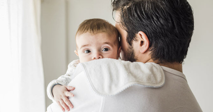 father kissing his baby