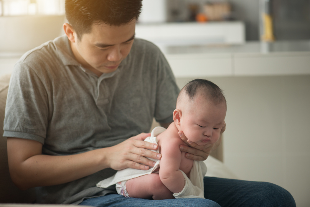 How to burp a baby sitting on your lap.