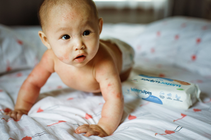 A baby crawling on a changing mat