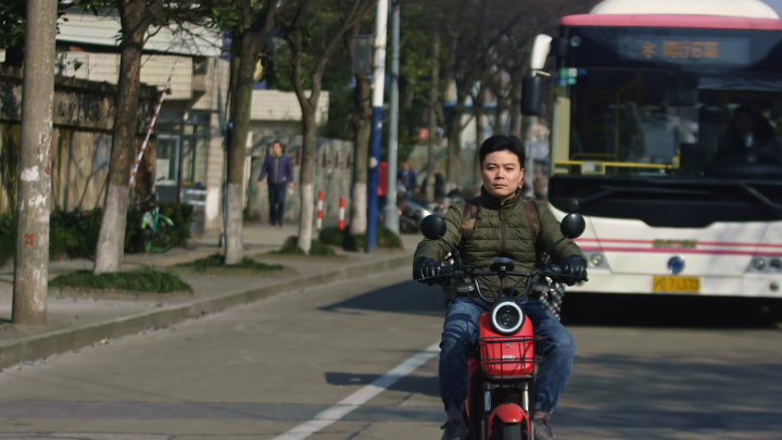 A mother riding a motorbike.