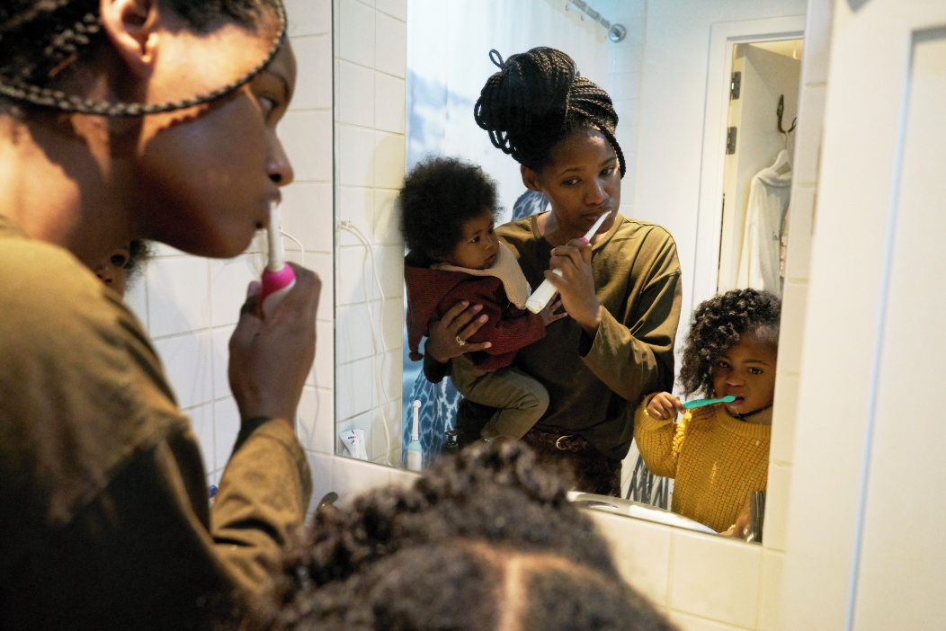 a mum brushing her teeth with her children