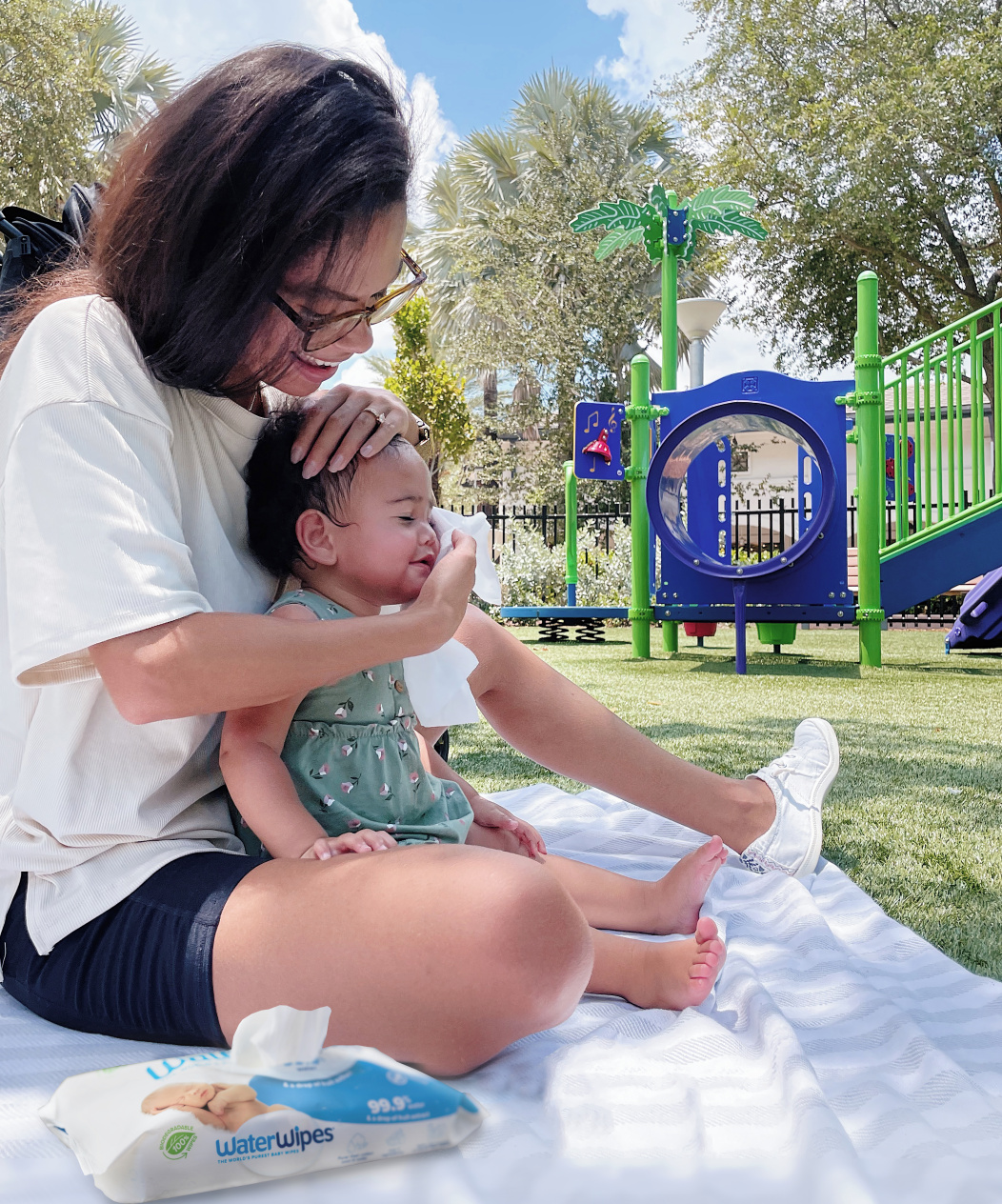 mum wiping baby's face with waterwipes