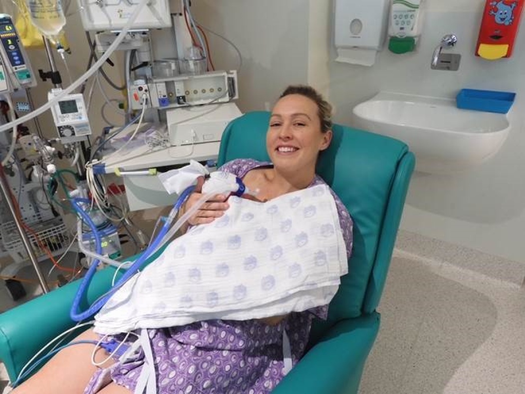 A mother practicing kangaroo care with her baby in a hospital